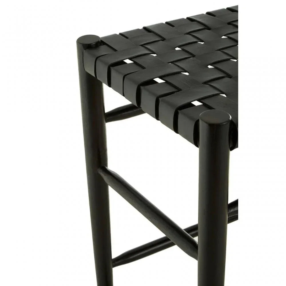 Black woven leather seat on a wooden stool frame, close up of corner detail