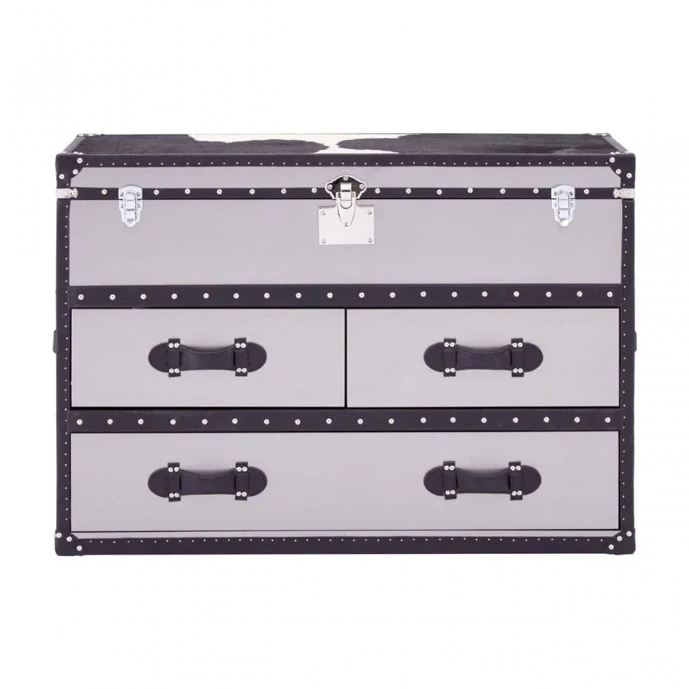 Grey storage trunk with studded trim and black leather handles, three drawers visible