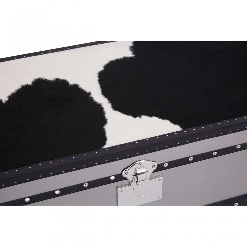 Cowhide storage trunk with black and white pattern and silver latch detail close-up