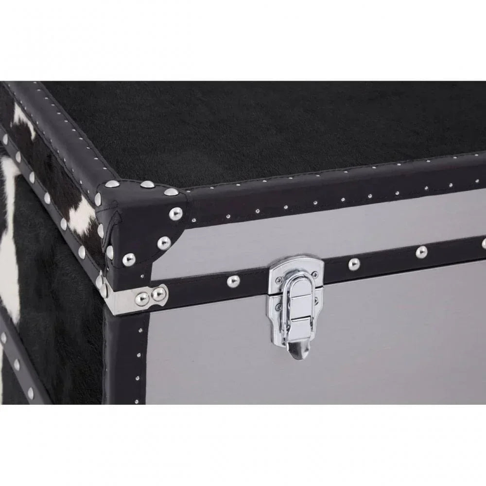 Cowhide storage trunk with black and white hide, silver metal trim and latch detail