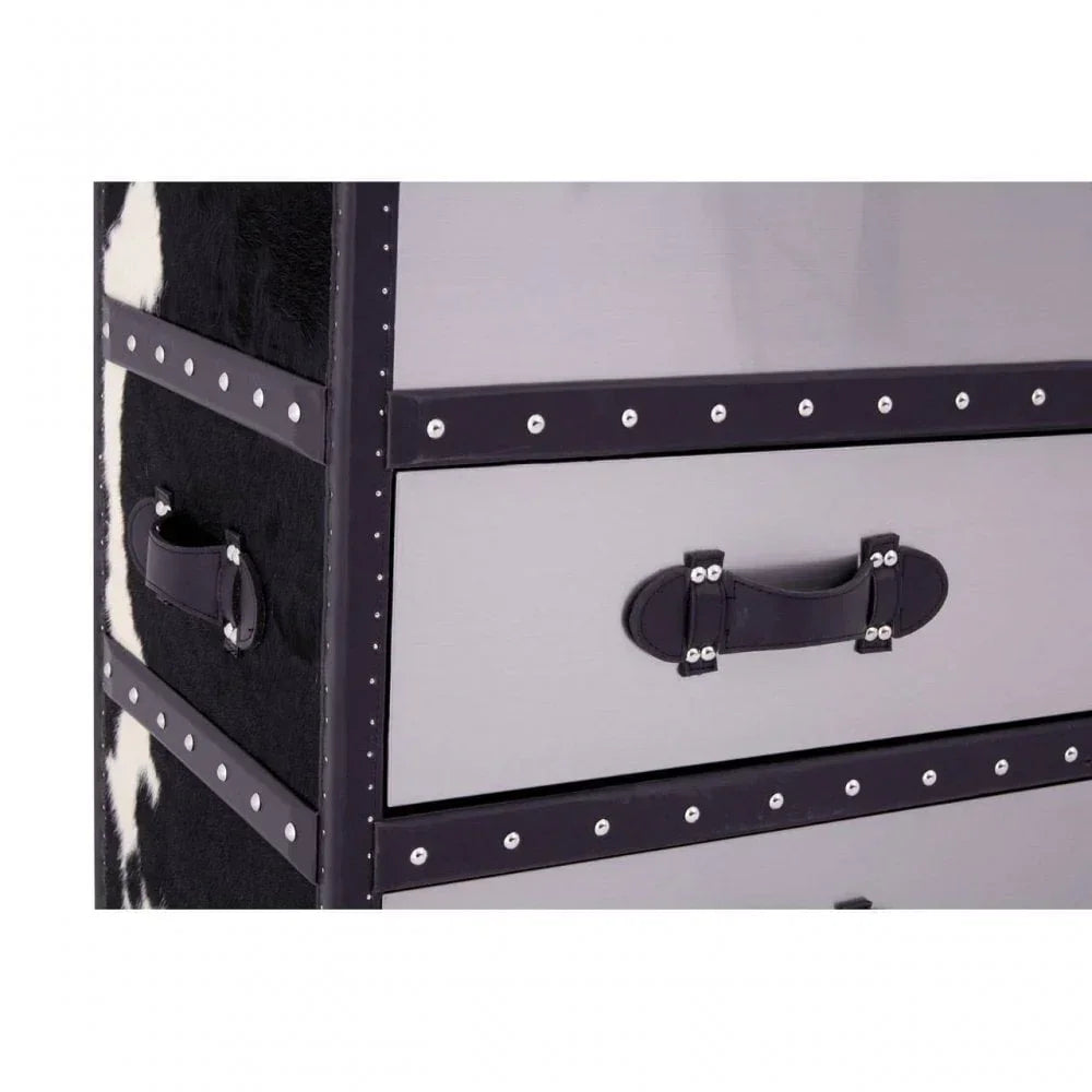 Closeup of studded drawer chest with black and white cowhide detail and leather handles