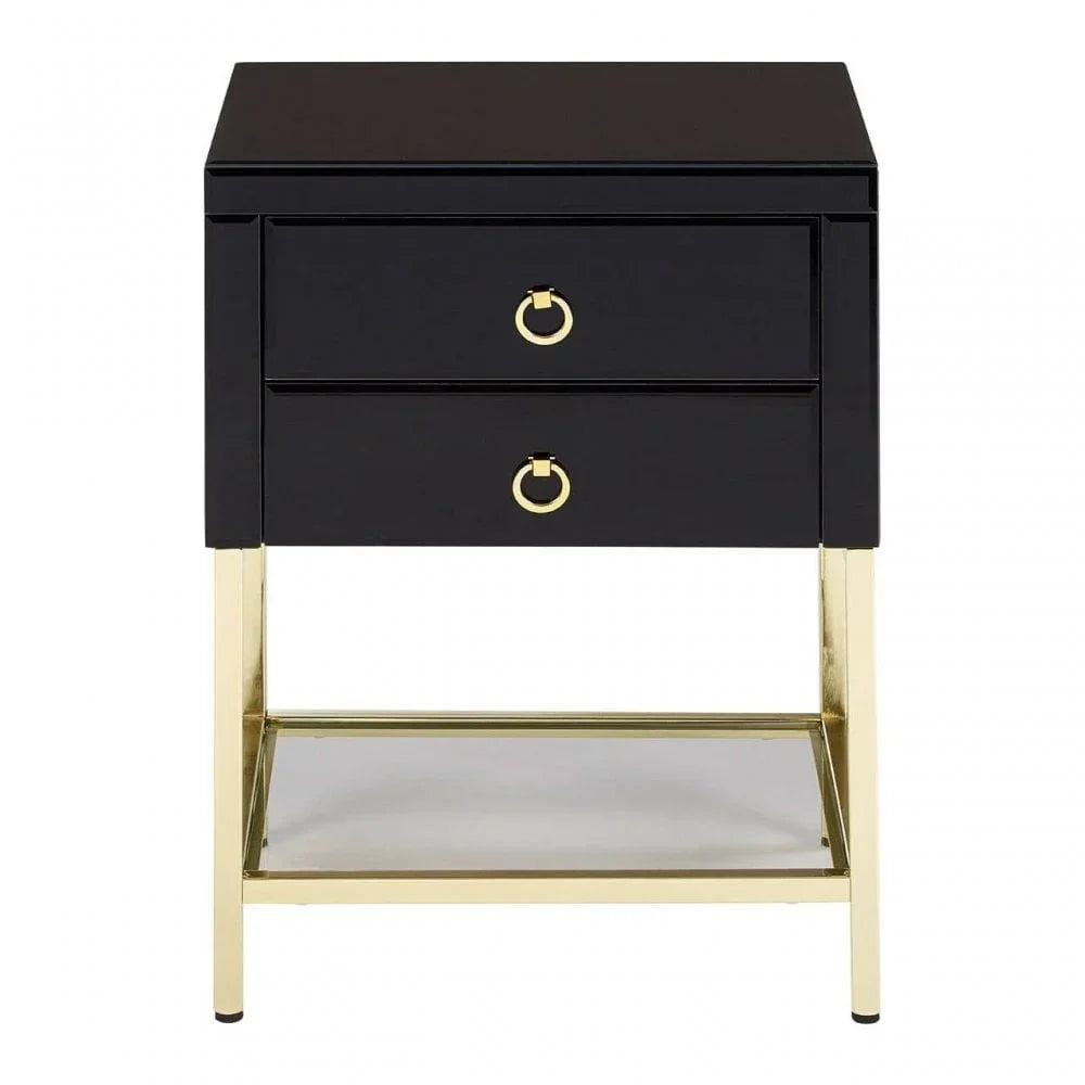 Black bedside table with gold metal legs and two drawers with gold ring handles, front view