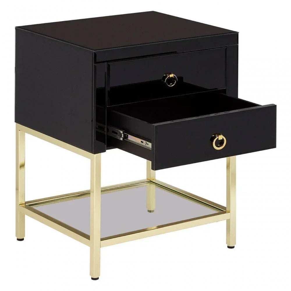 Black bedside table with gold frame, two drawers open, and glass shelf underneath