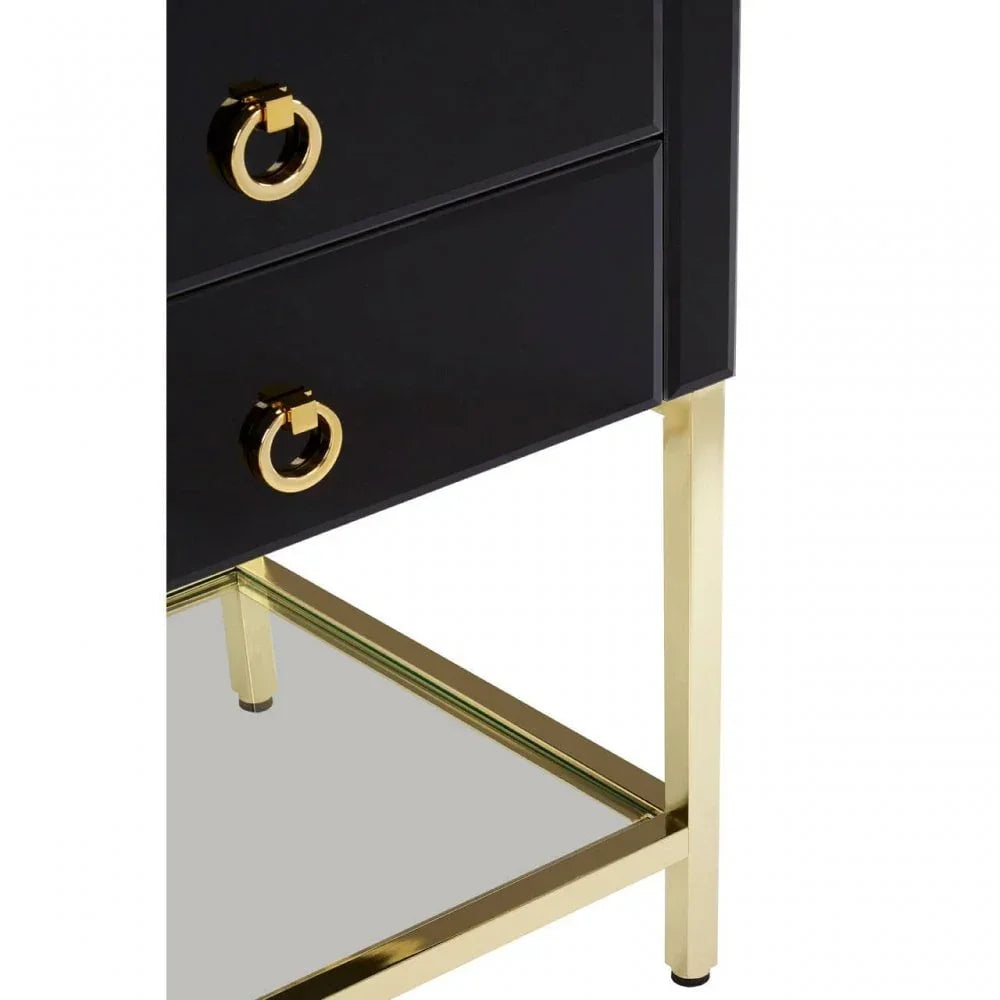 Black bedside table with gold drawer handles and mirrored shelf on gold frame