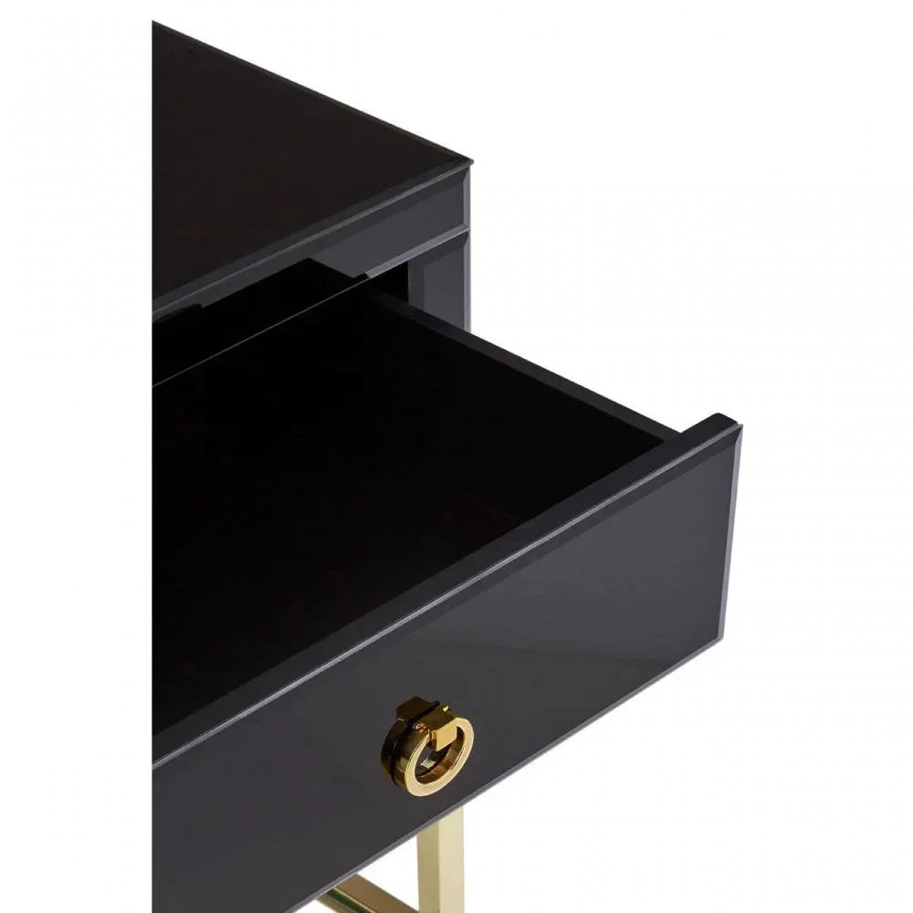 Black bedside table drawer with gold handle and glossy finish, drawer partially open