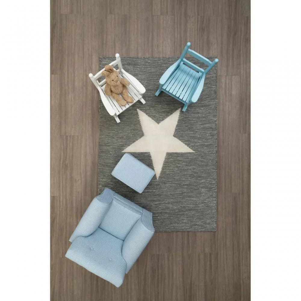 Grey star rug with blue armchair, footstool, and toy rocking chairs on wood floor