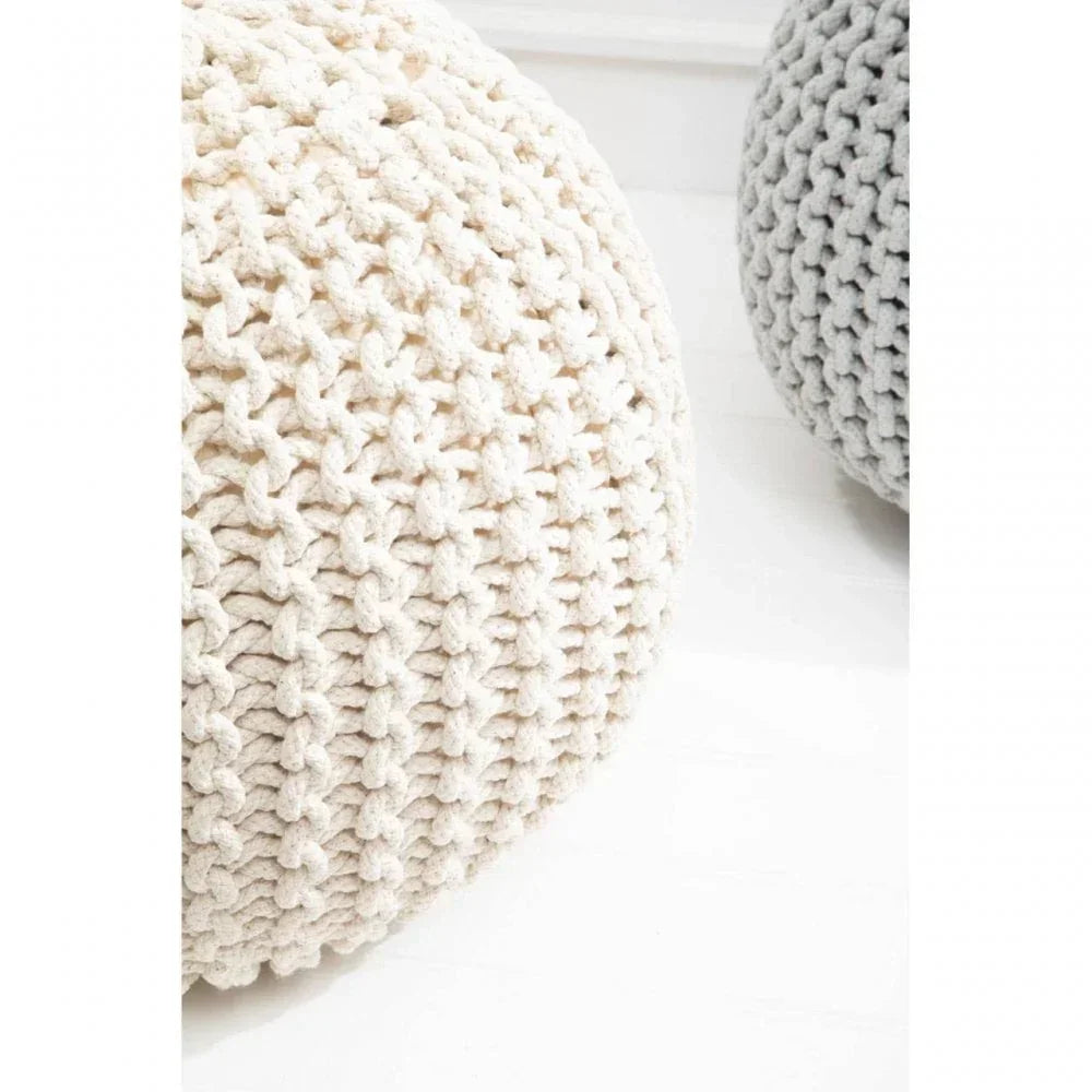 Cream knitted footstool pouffe with textured chunky yarn beside light grey pouffe on floor