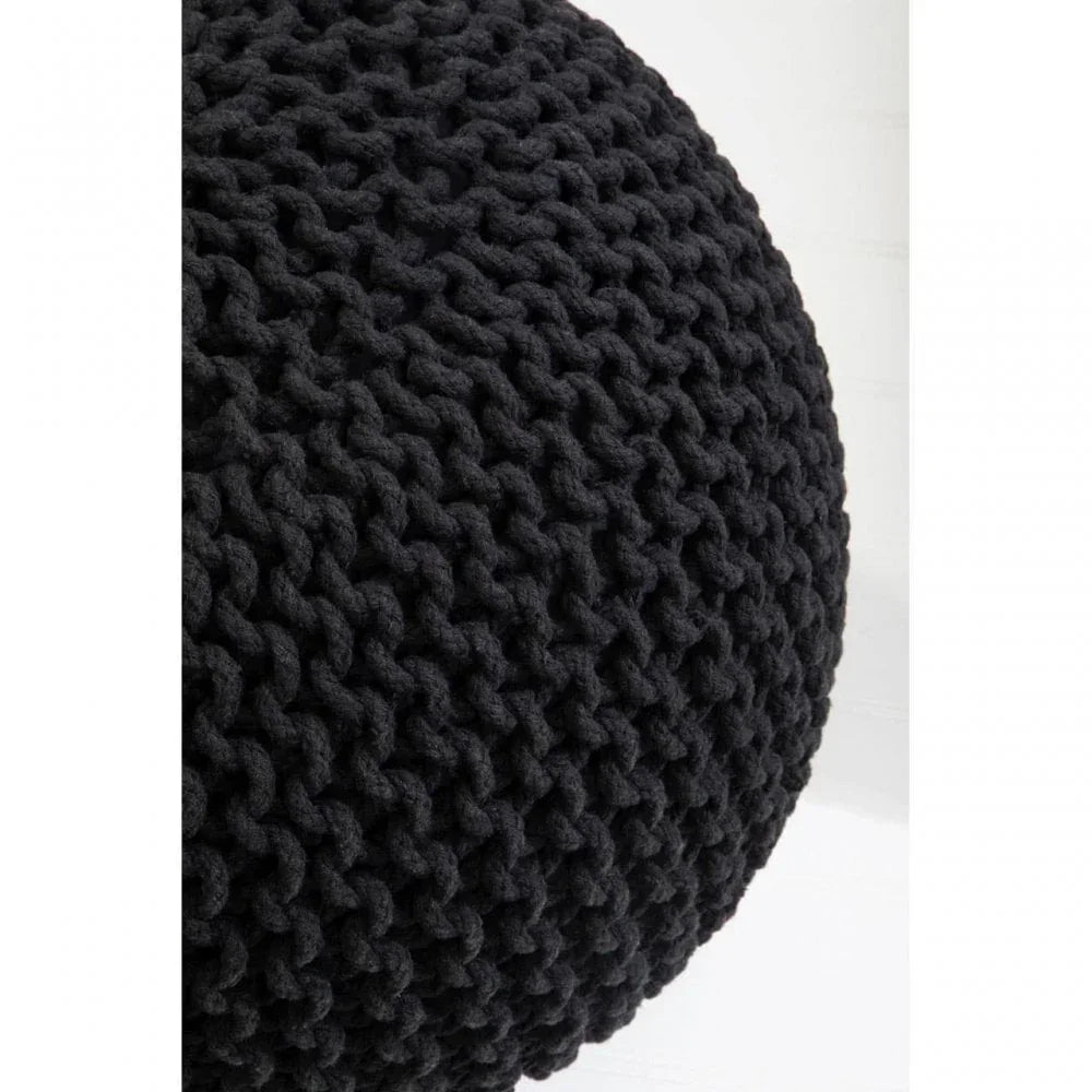 Black knitted pouffe close-up showing chunky woven texture and round shape