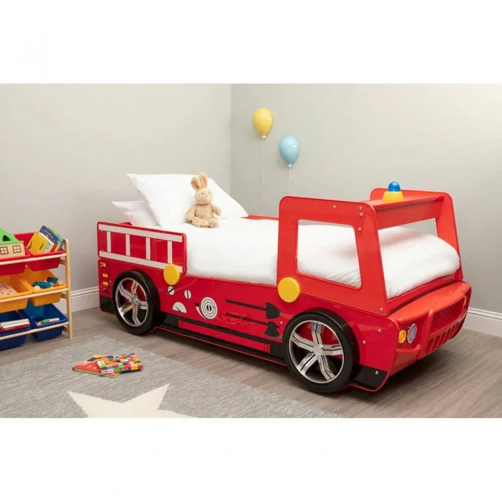 Red fire engine kids bed with wheels and side rails in a child's bedroom