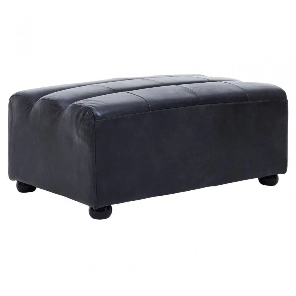 Black leather footstool with stitched top and rounded legs on white background