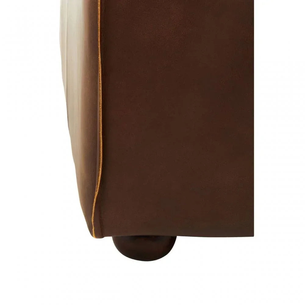 Brown leather sofa corner with wooden foot and contrast piping detail