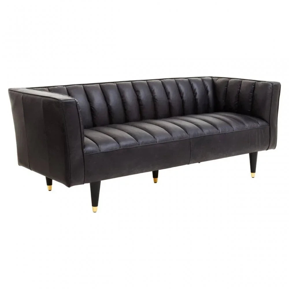 Black leather sofa with vertical stitched upholstery and tapered legs with gold tips