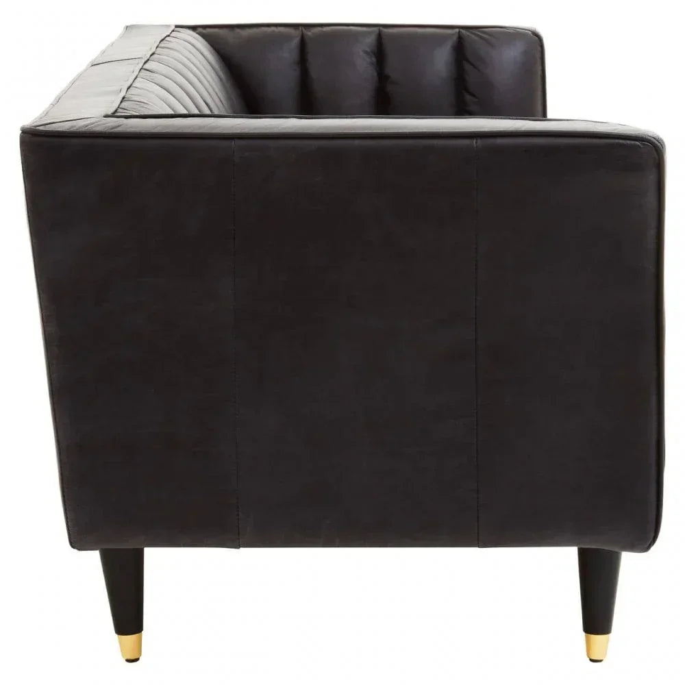 Black leather sofa side view with vertical tufted back and gold-tipped legs