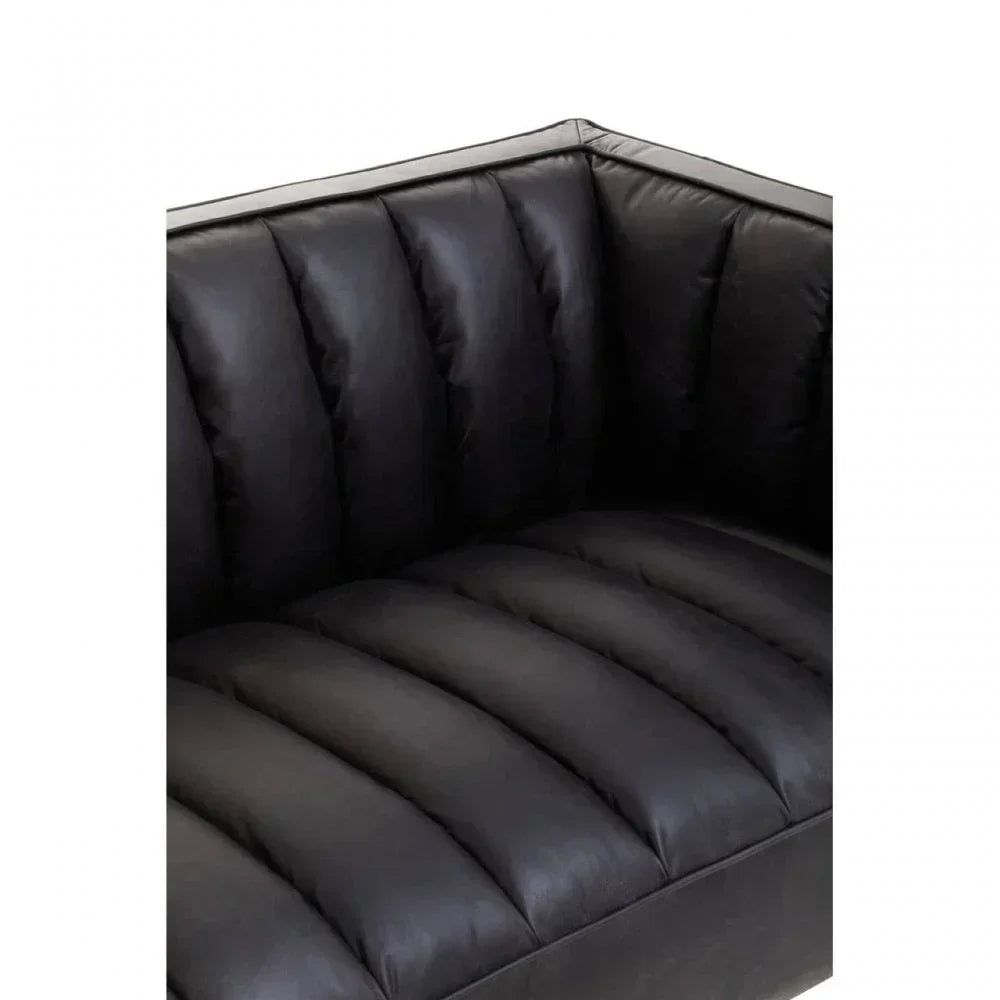 Close-up of black leather sofa corner with deep channel tufted cushions