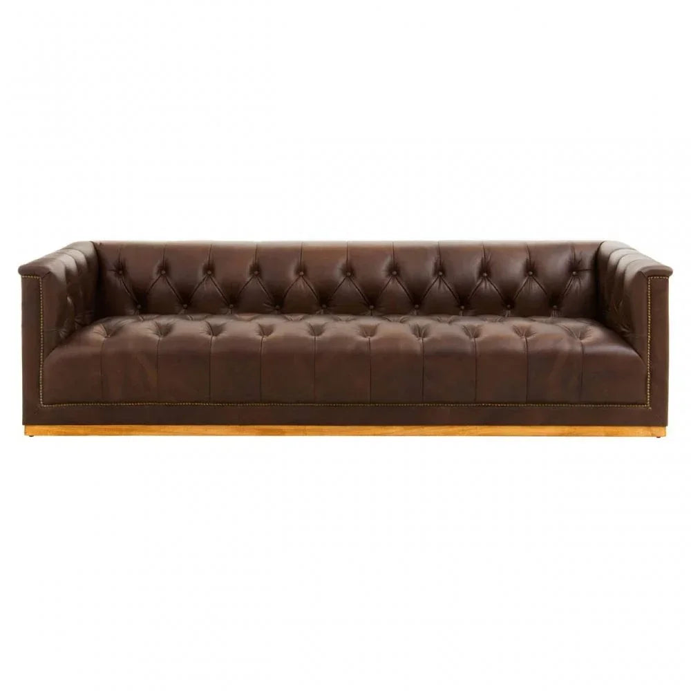 Brown leather sofa with deep button tufting and wooden base, front facing angle