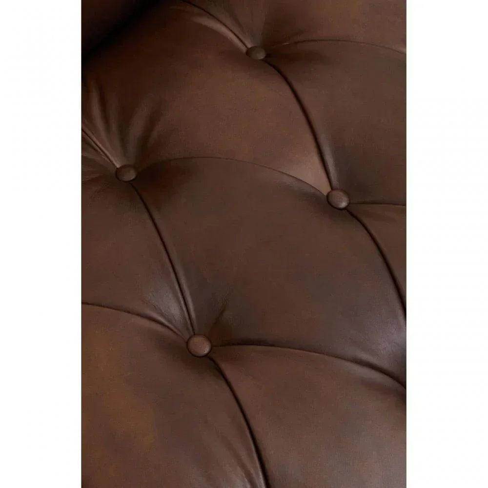 Brown leather sofa upholstery with deep button tufting close up