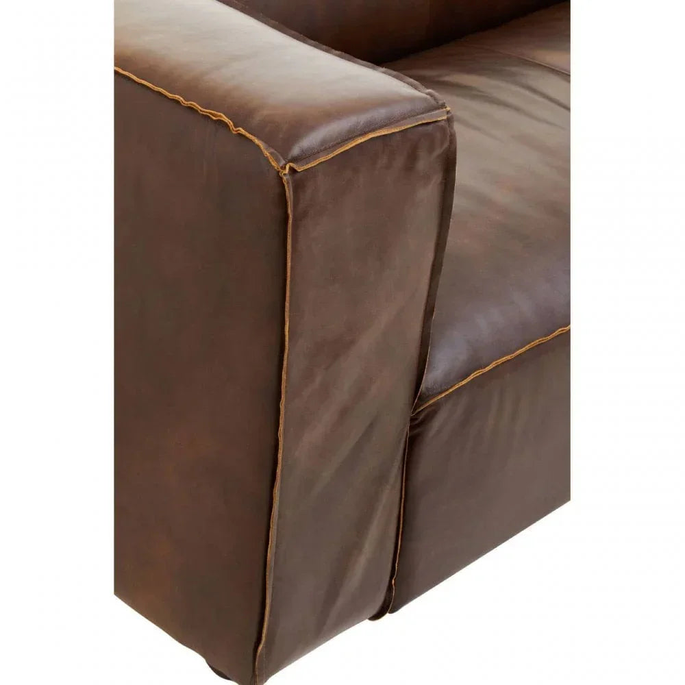 Brown leather sofa armrest with contrast stitching, close-up view of cushion and upholstery