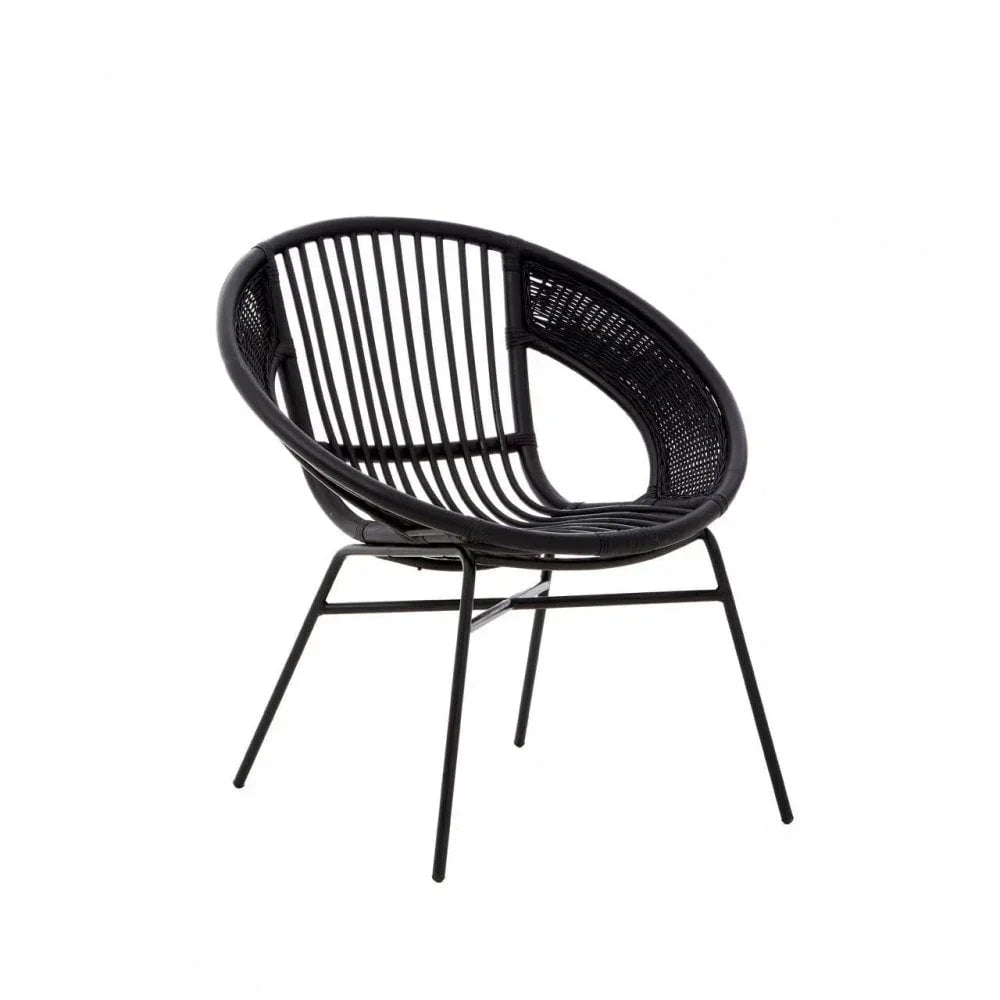 Black rattan lounge chair with round seat and metal legs on white background