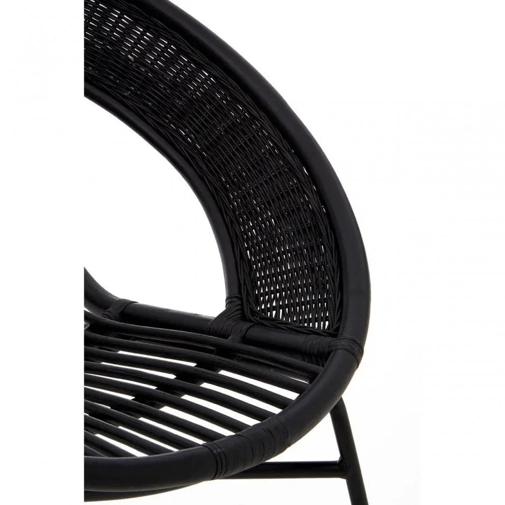 Close-up of black rattan chair frame and woven backrest detail
