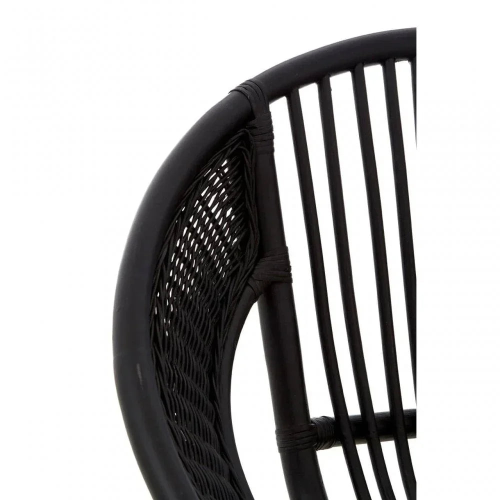 Close-up of black rattan chair backrest showing woven and rod detailing