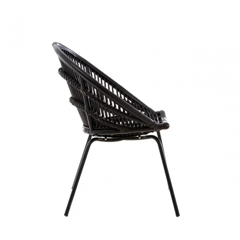Black rattan lounge chair with angled metal legs and woven backrest, side view