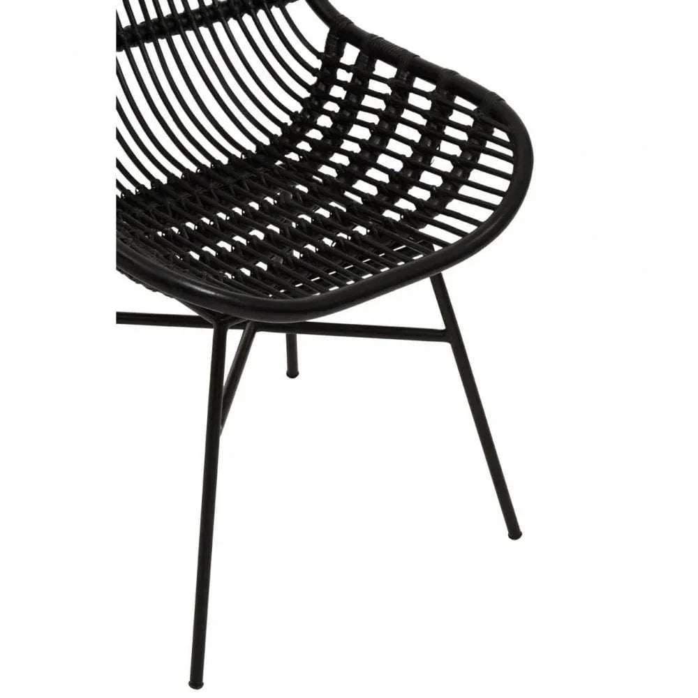Black rattan dining chair with curved seat and metal legs, side angle view