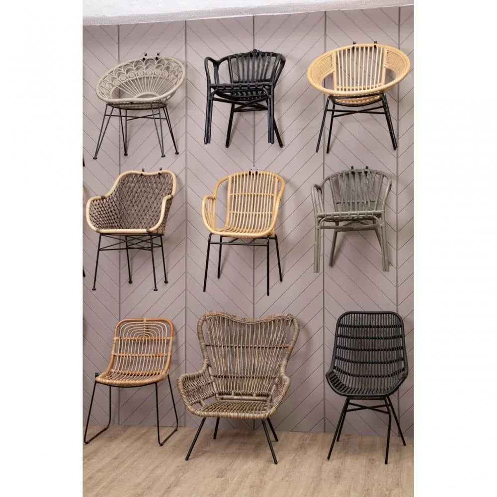 Selection of rattan accent chairs with metal legs displayed on herringbone wall and wood floor