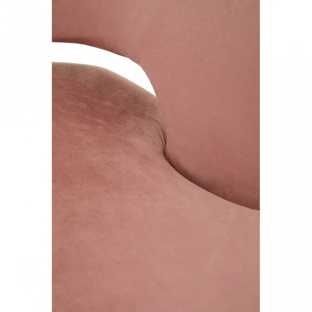 Close-up of blush pink velvet chair seat and curved backrest