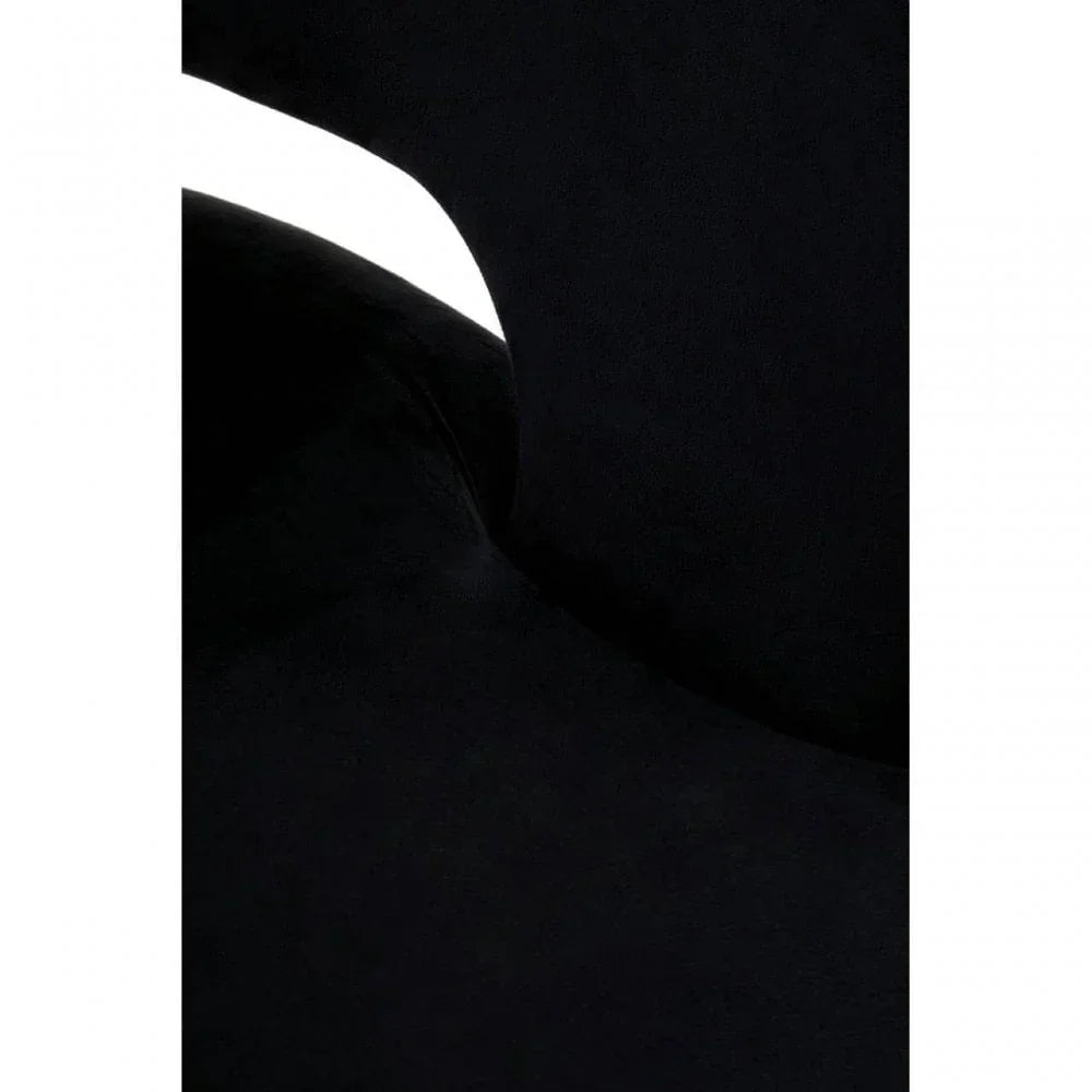 Closeup of black velvet chair seat and backrest with curved seam detail
