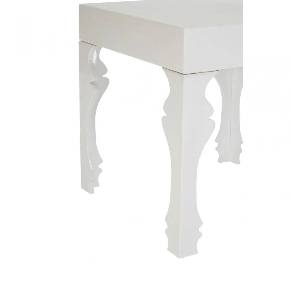 White wooden stool with decorative carved legs, close-up of corner and leg details