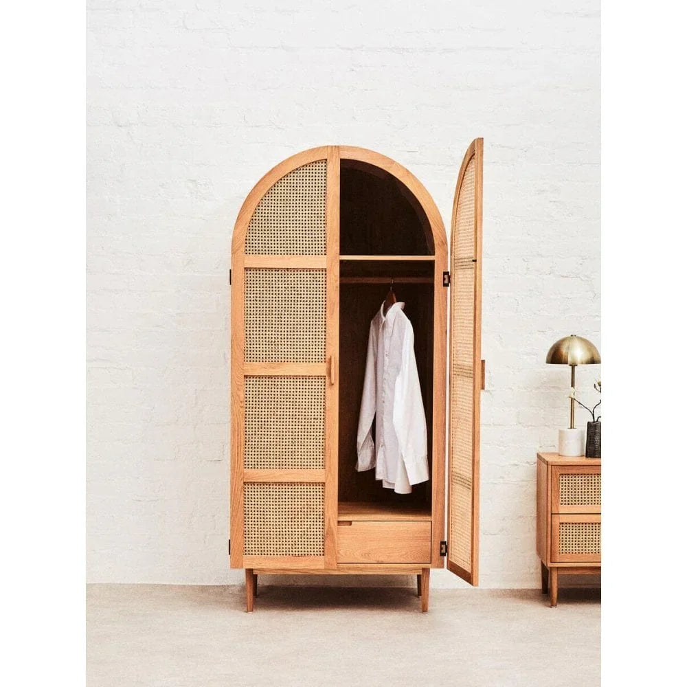 Natural wood rattan wardrobe with arched doors, hanging rod and drawer, open to show shirt