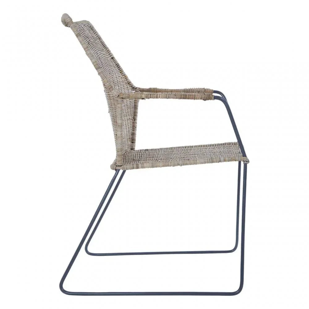 Wicker dining chair with black metal legs viewed from the side