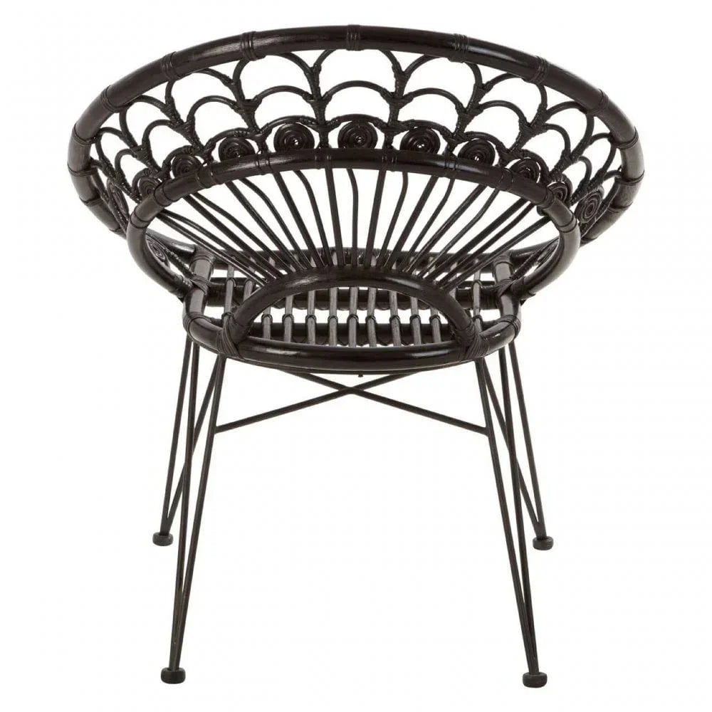 Black rattan accent chair with metal legs and curved backrest, rear view