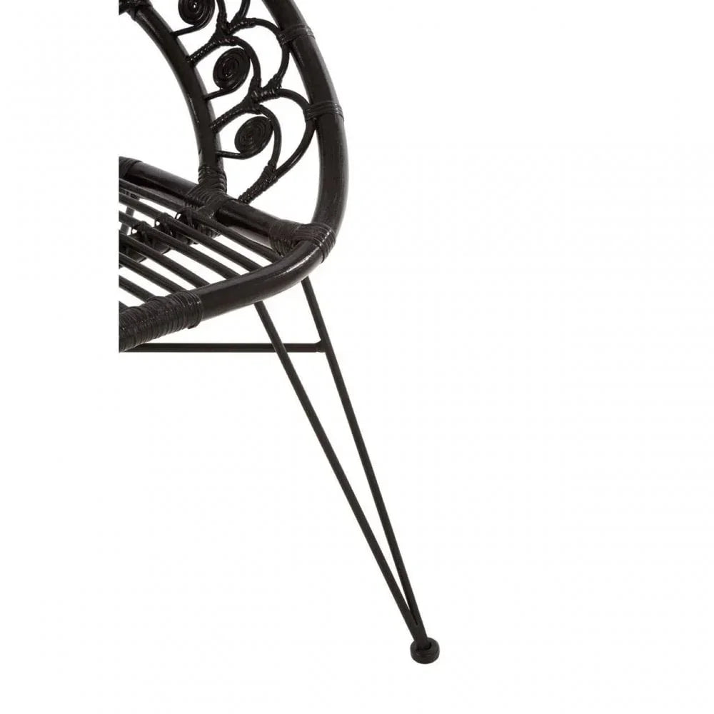 Black rattan chair with decorative backrest and metal leg frame, close-up view