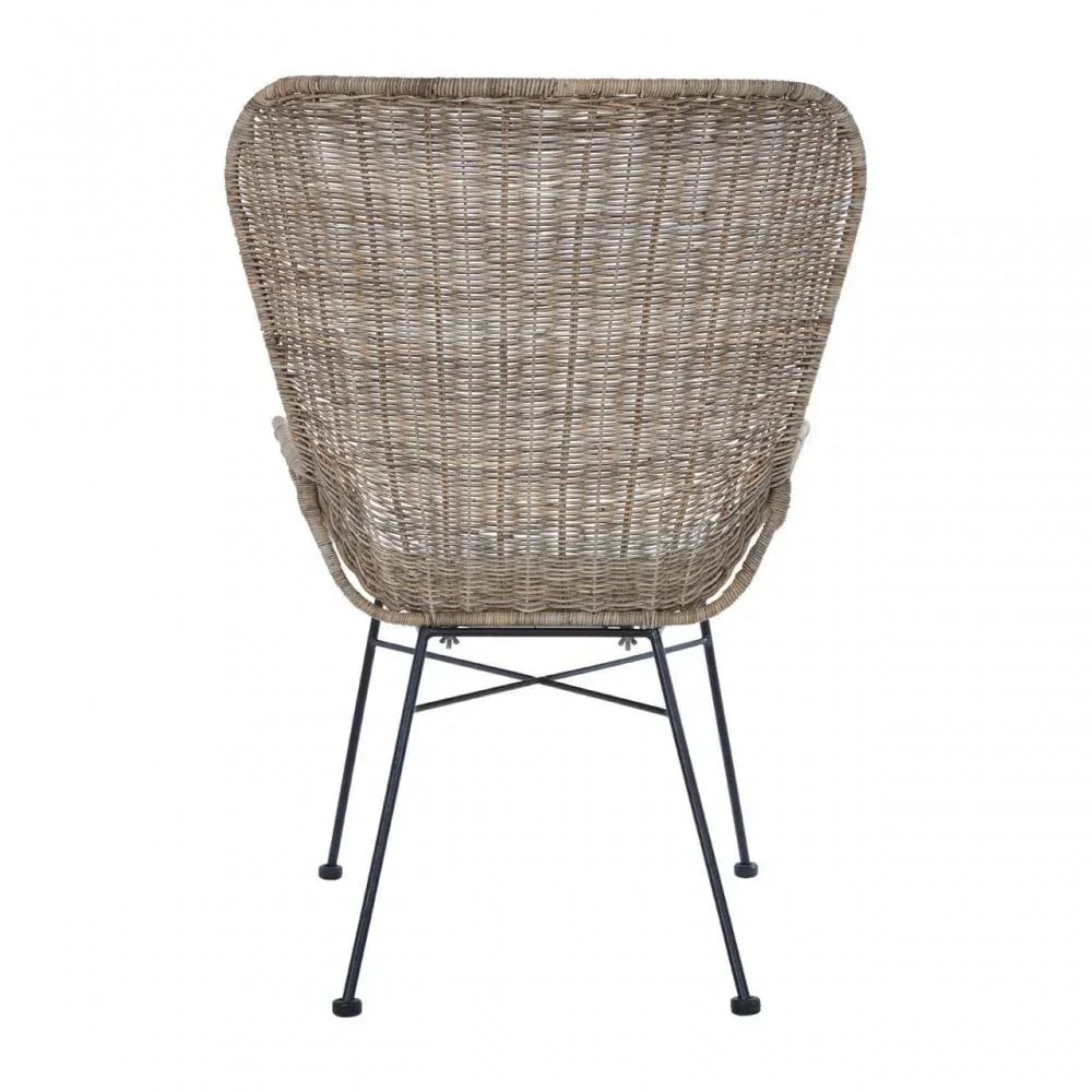 Back view of rattan dining chair with woven wicker seat and black metal legs