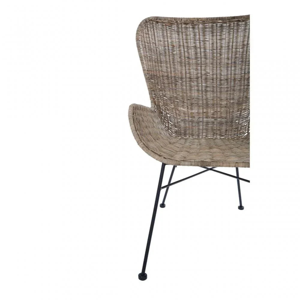 Curved rattan dining chair with black metal legs, partial side view