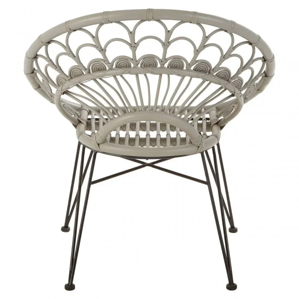 Round rattan accent chair with woven back and black metal legs, rear angle view