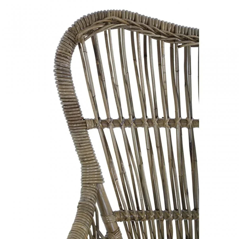 Closeup of natural rattan chair backrest showing woven detail and curved frame