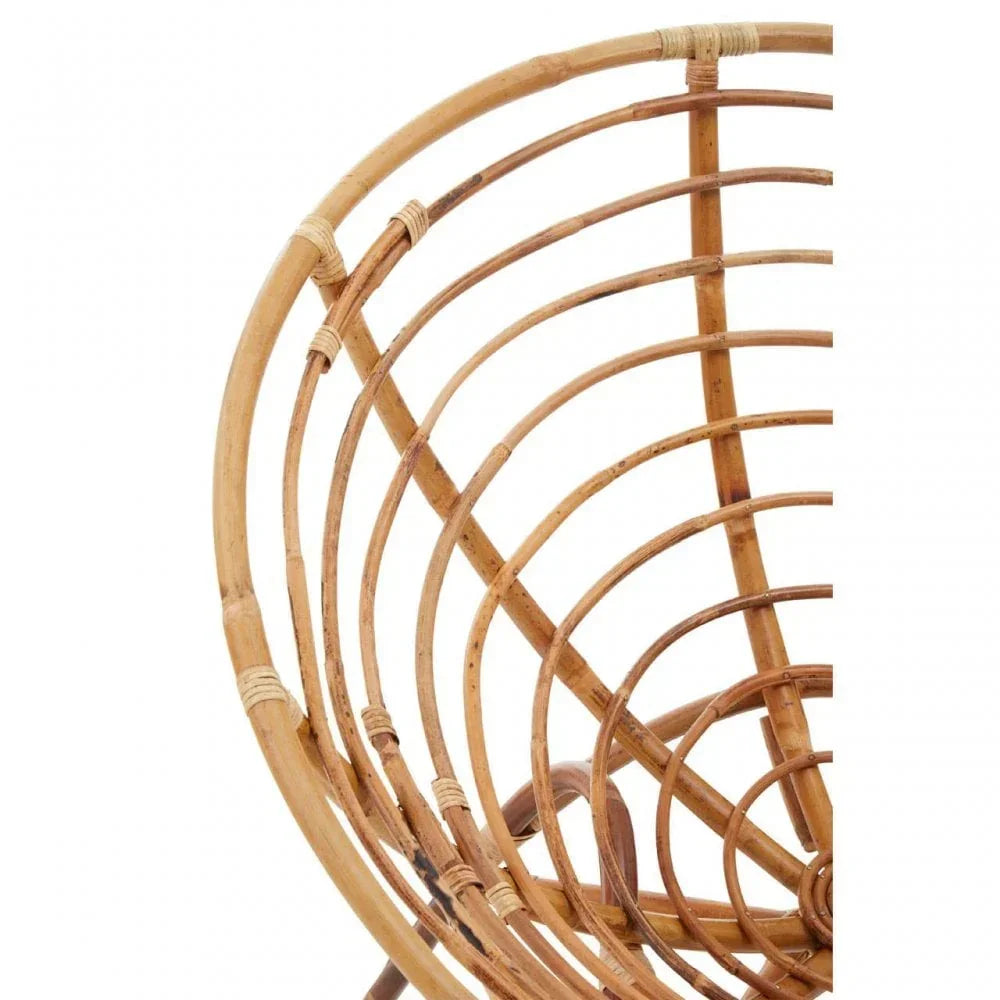 Closeup of rattan chair frame showing curved natural cane detail and woven joints