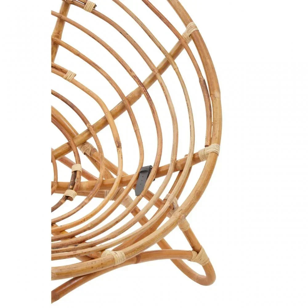 Close up of natural rattan chair frame showing curved woven structure and binding detail