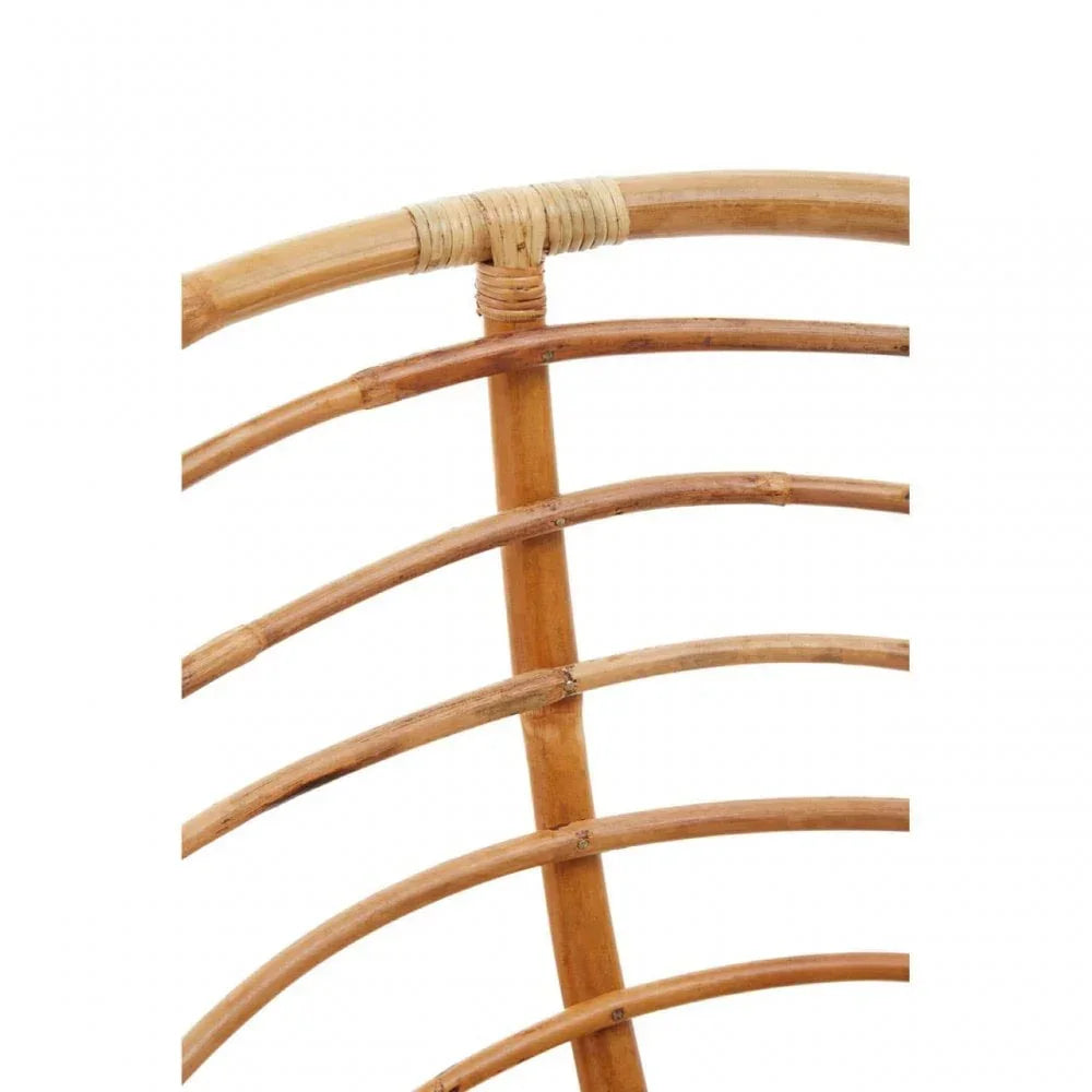 Close-up of curved rattan furniture frame with natural wicker binding and wood texture