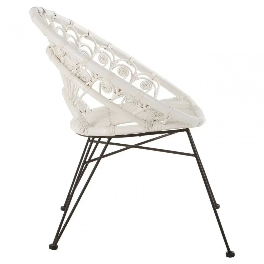White rattan accent chair with circular backrest on black metal legs, side view