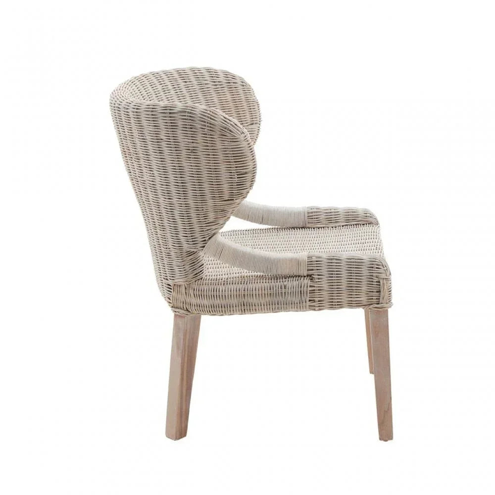 Side view of a beige rattan armchair with curved back and wooden legs