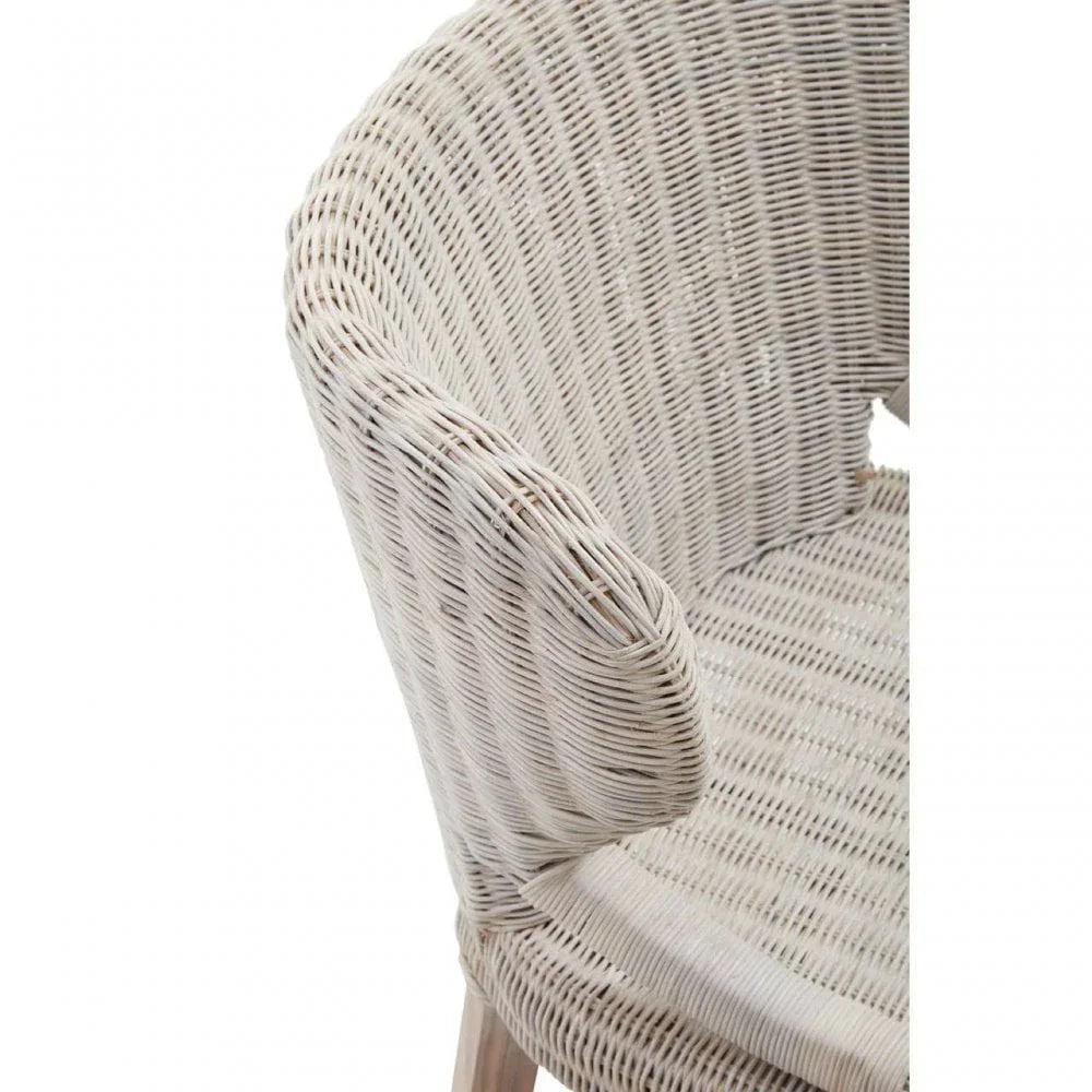 Close view of light rattan chair with curved armrest and woven seat detail