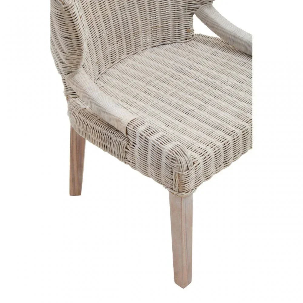 Light rattan dining chair with woven seat and wooden legs, partial front side view