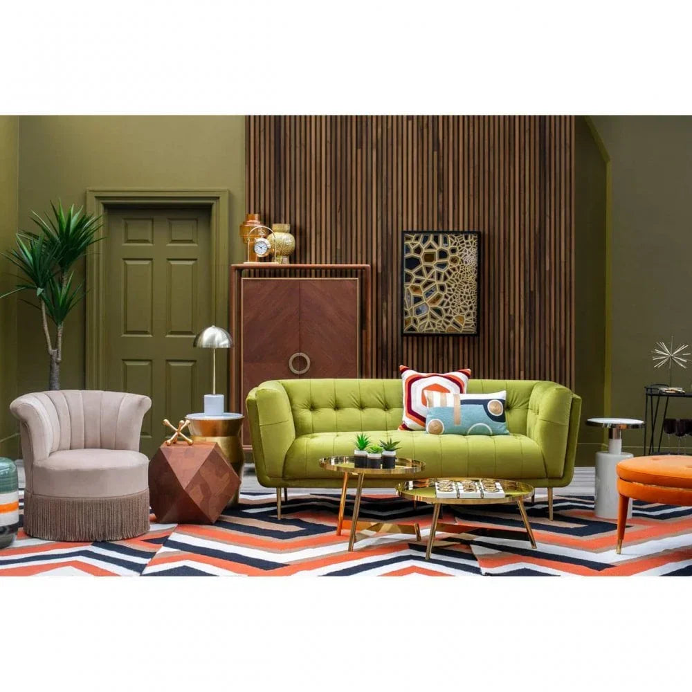 Green upholstered sofa and accent chair in modern living room with geometric rug