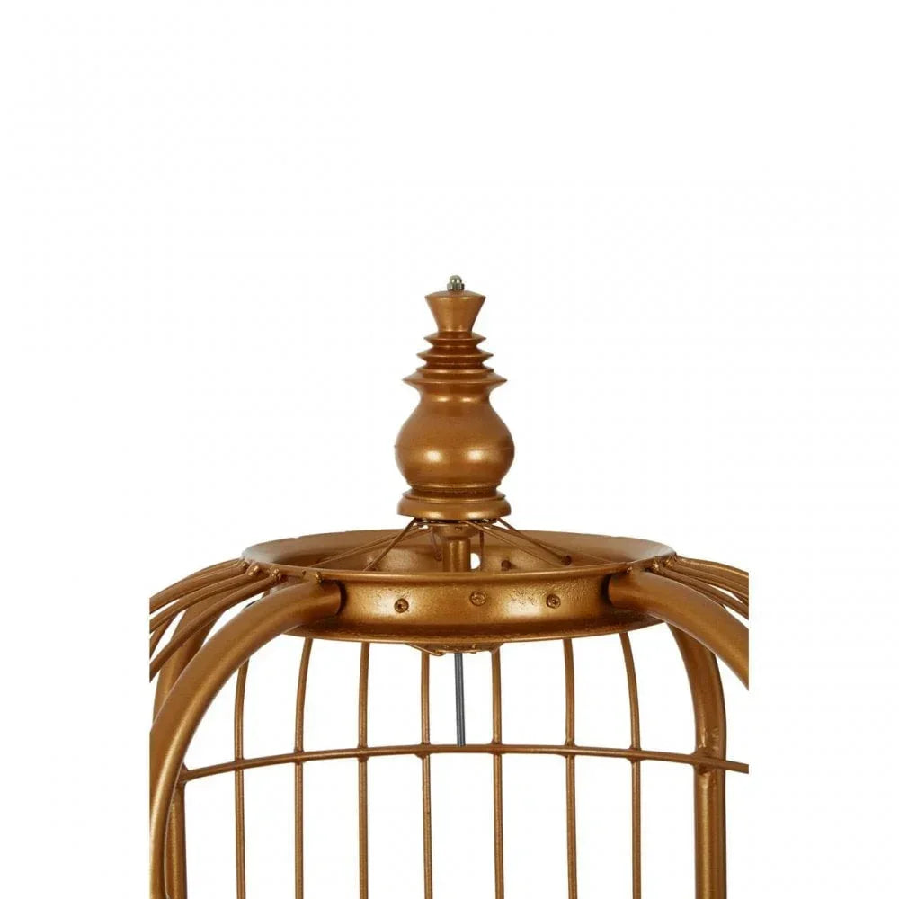 Gold metal birdcage finial detail with curved bars and decorative top accent