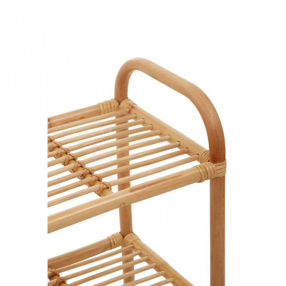 Closeup of rattan shelving unit with natural wood finish and vertical slat design