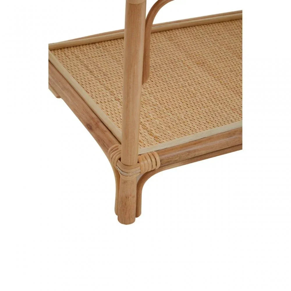 Corner detail of rattan side table with woven shelf and light wood frame