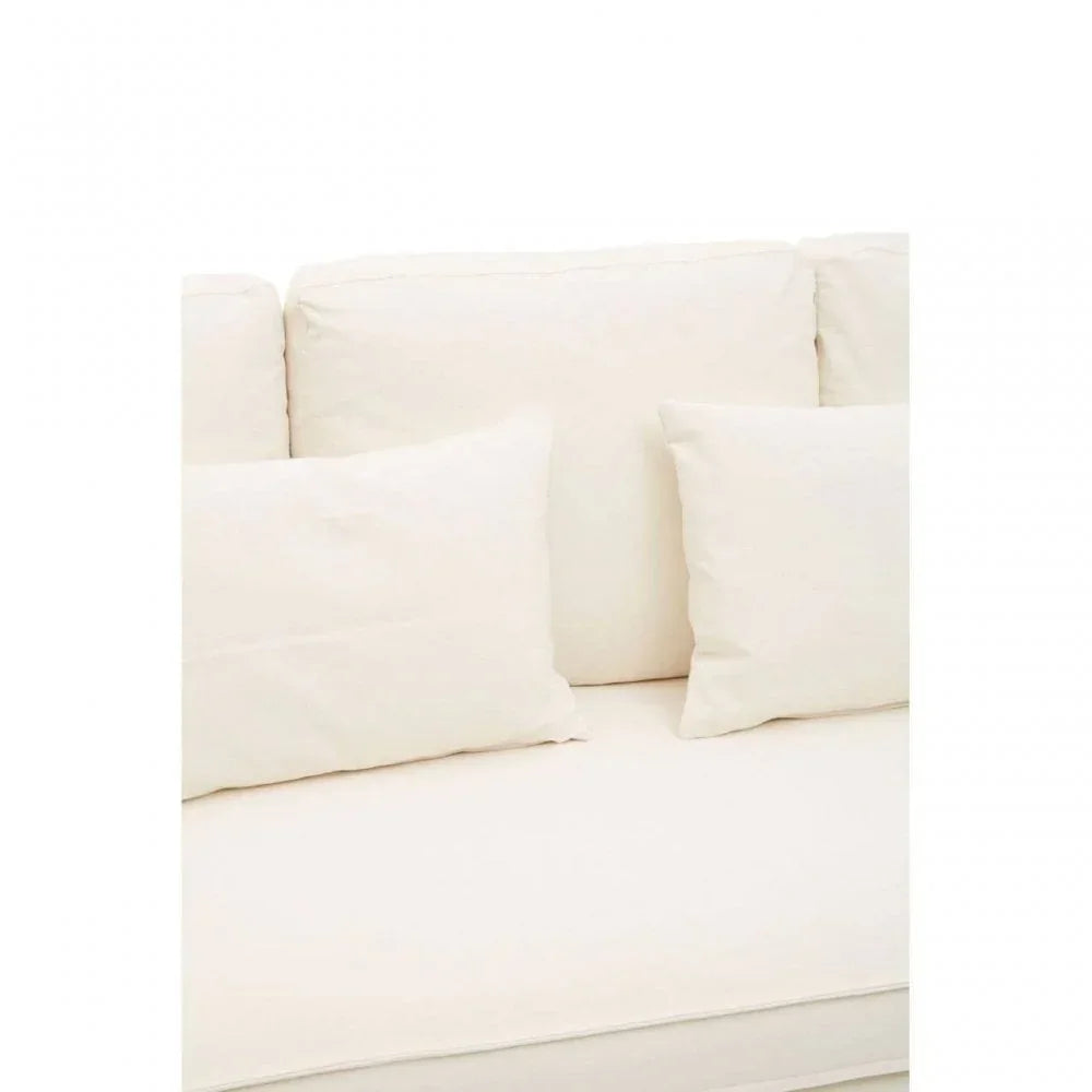 Cream fabric sofa cushions arranged on a matching cream upholstered sofa